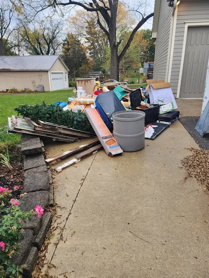Dumpster being loaded with debris for Residential Dumpster Rental in Red Bay